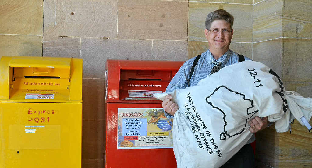 Postal services officer Kyle Hughes with a bag of mail to be sorted at the Warwick Post Office. Postal services officer Kyle Hughes with a bag of mail to be sorted at the Warwick Post Office.
